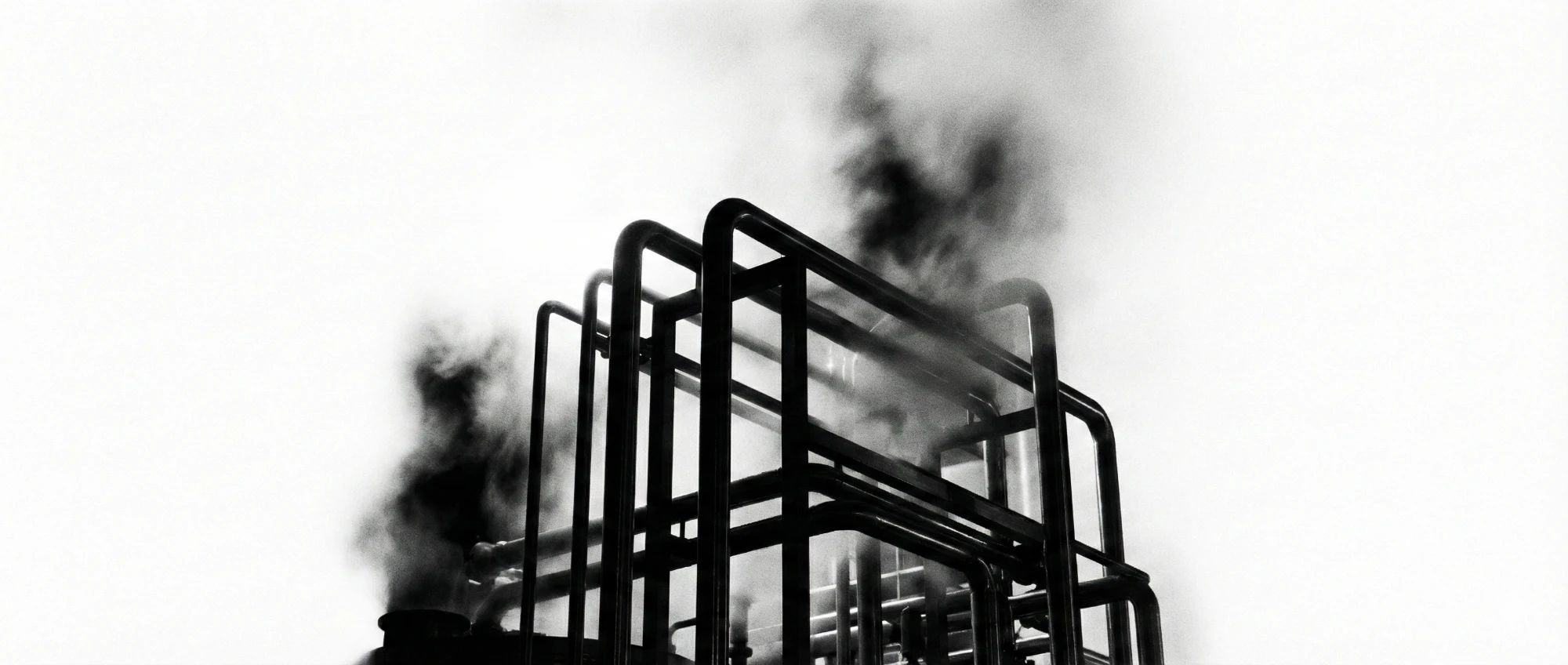 Black steel pipes in white smoke
