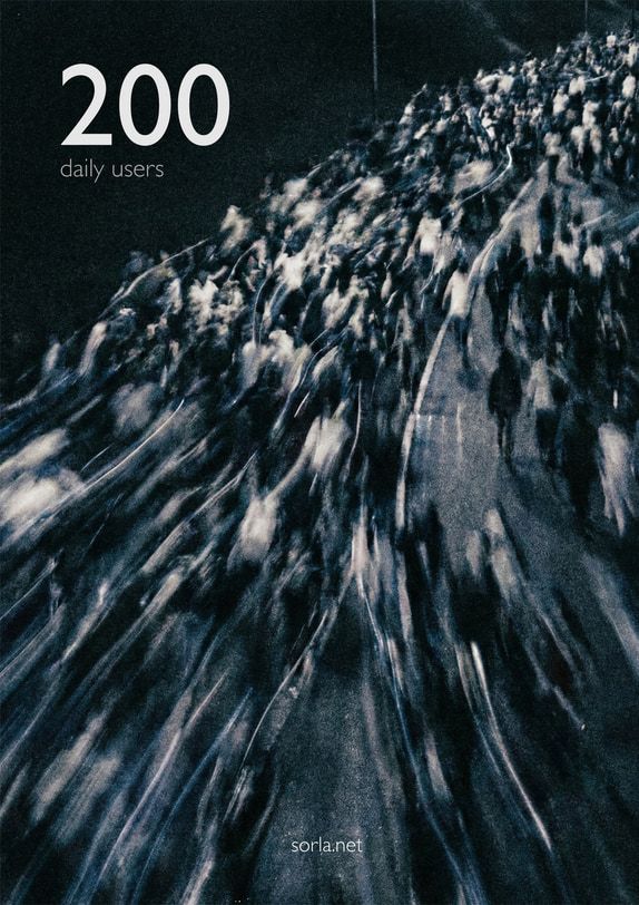 A poster reading 200 daily users over a blurred crowd at night