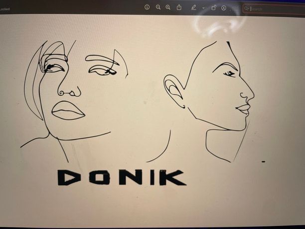 A photo of a screen: the two line-drawn faces above DONIK in heavy black letters